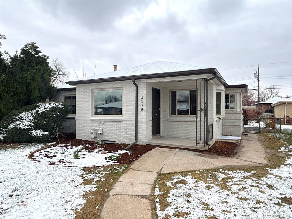 3578 Ivanhoe St, Denver, CO 80207 - bungalow with brick siding and fence