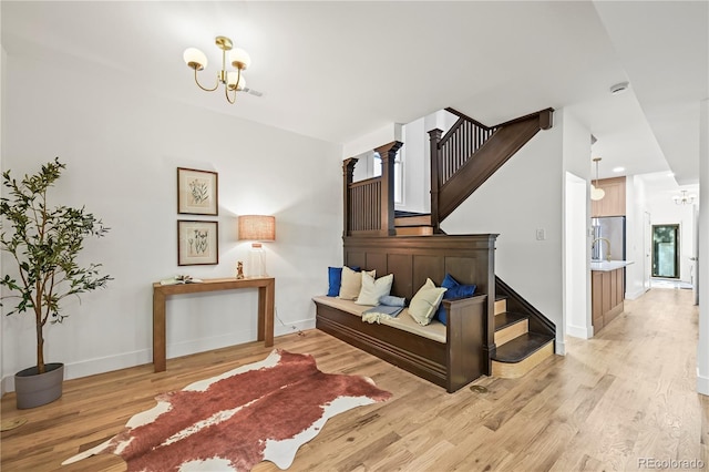 734 N Downing St, Denver, CO 80218 - staircase featuring a chandelier and wood finished floors