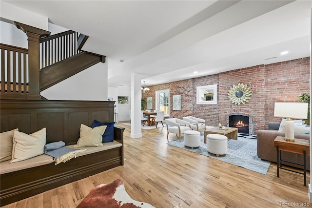 734 N Downing St, Denver, CO 80218 - living area featuring brick wall, a brick fireplace, wood finished floors, and recessed lighting