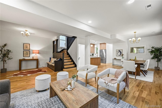 734 N Downing St, Denver, CO 80218 - living room featuring a chandelier, light wood-style floors, stairway, and recessed lighting