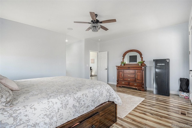 bedroom featuring light wood-type flooring, ceiling fan, and baseboards