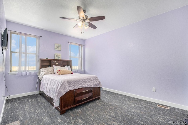 bedroom featuring multiple windows, visible vents, and baseboards