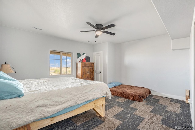 carpeted bedroom featuring visible vents, ceiling fan, and baseboards