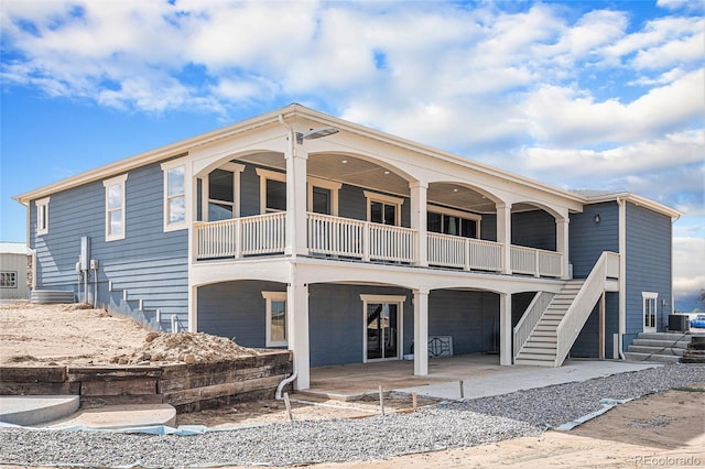 view of front of house with stairs and a patio