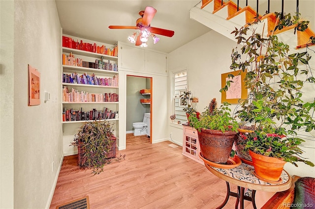 sitting room featuring a ceiling fan and wood finished floors