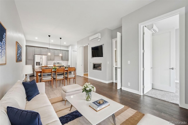 living room featuring an AC wall unit and dark wood-type flooring