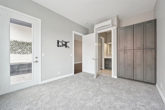 unfurnished bedroom featuring light colored carpet and a wall mounted AC