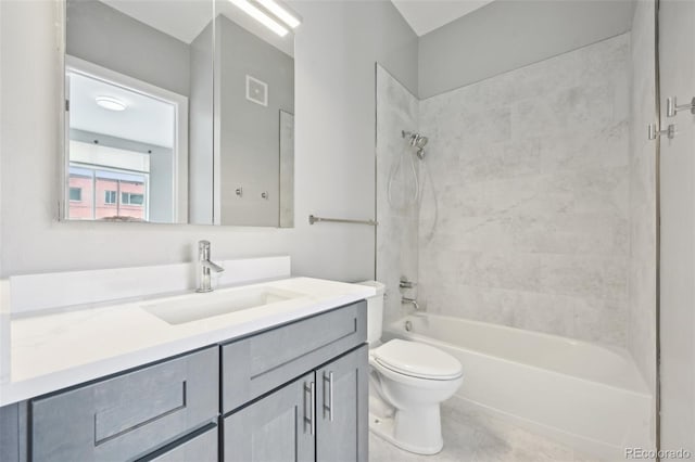 full bathroom featuring vanity, tile patterned flooring, tiled shower / bath combo, and toilet