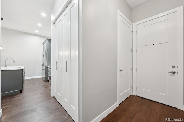 hallway featuring dark hardwood / wood-style flooring and sink