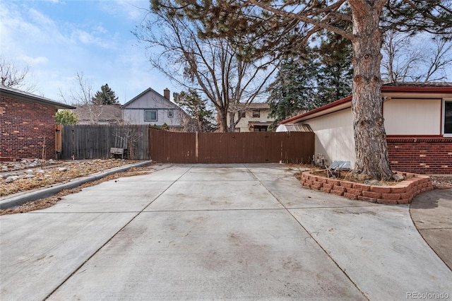 exterior space featuring brick siding and fence