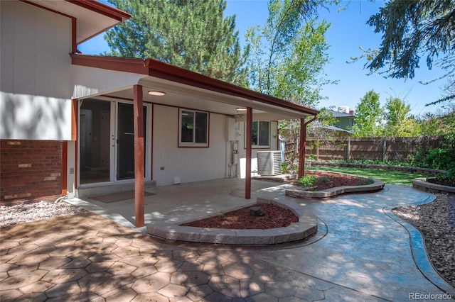 view of patio / terrace with central air condition unit and fence