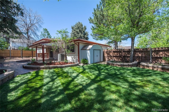view of yard featuring central air condition unit, a patio, an outdoor structure, and a fenced backyard