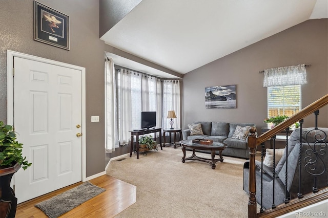 entryway featuring plenty of natural light, baseboards, stairs, and wood finished floors