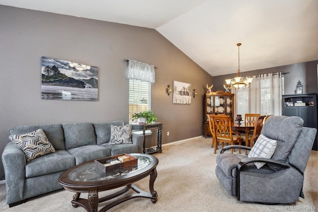 living area featuring an inviting chandelier, lofted ceiling, a healthy amount of sunlight, and light carpet