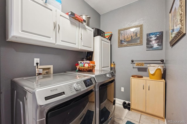 washroom with baseboards, washer and clothes dryer, cabinet space, and light tile patterned flooring