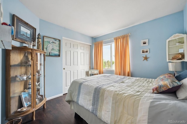 bedroom with baseboards, a closet, and wood finished floors