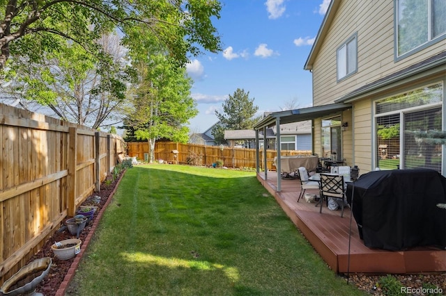 view of yard with a fenced backyard and a deck