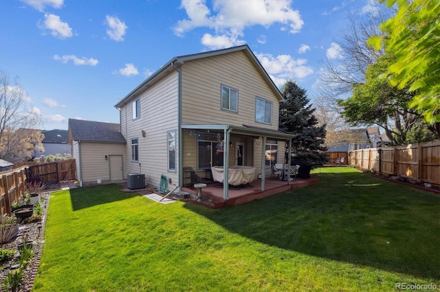 rear view of property featuring a lawn, a fenced backyard, a patio area, and central AC