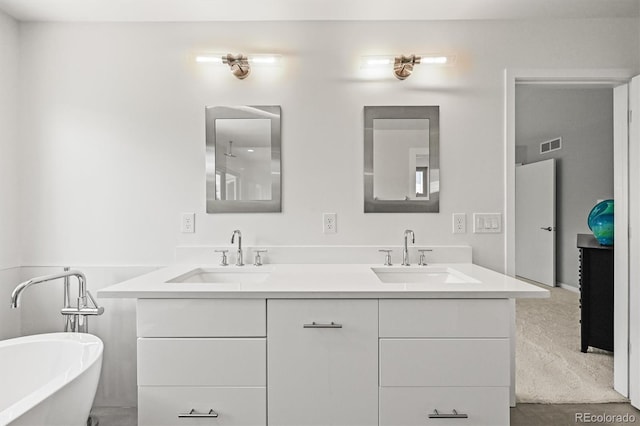 full bathroom with a freestanding bath and double vanity