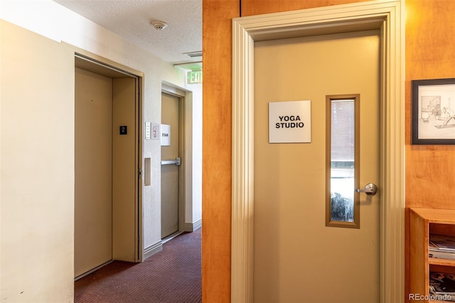2650 Front Vw Unit 205, Denver, CO 80211 - corridor featuring dark colored carpet, elevator, and a textured ceiling
