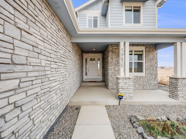 entrance to property featuring covered porch