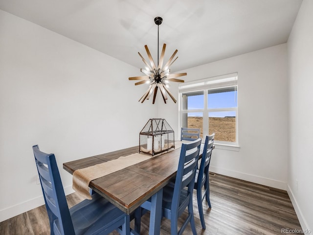 dining area featuring a chandelier and dark hardwood / wood-style floors