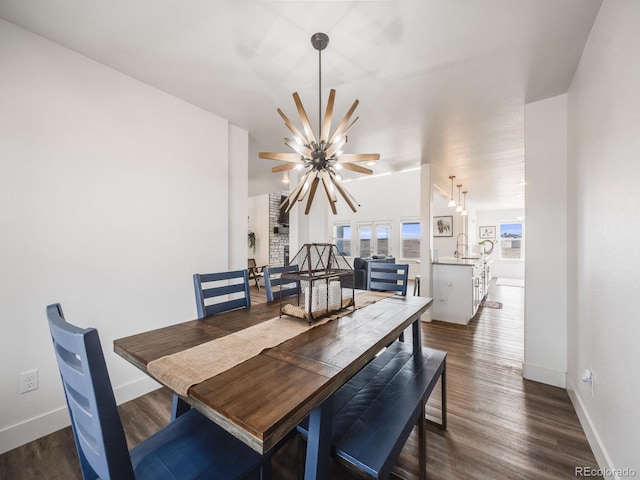 dining area featuring dark hardwood / wood-style flooring, a chandelier, and sink