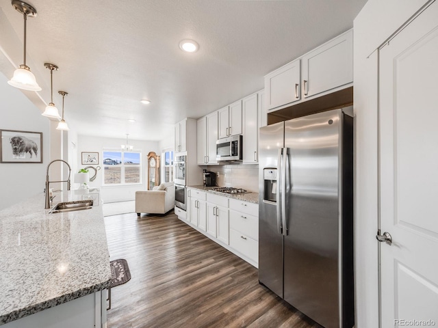 kitchen with white cabinetry, sink, dark hardwood / wood-style floors, and appliances with stainless steel finishes