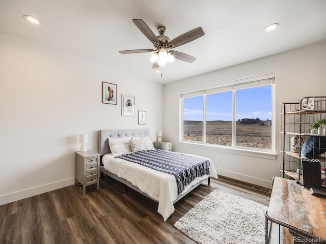 bedroom featuring ceiling fan and dark wood-type flooring