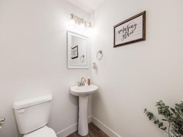 bathroom featuring hardwood / wood-style floors, toilet, and sink