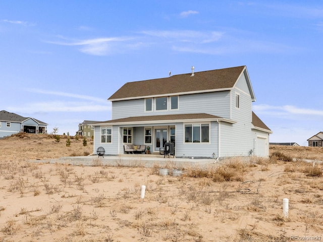 rear view of property featuring a garage