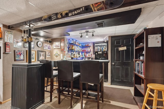 bar with carpet flooring, visible vents, a bar, and a drop ceiling