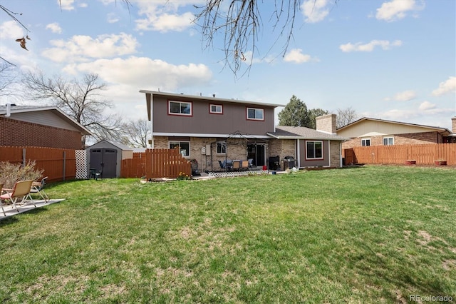 back of property featuring a storage shed, a patio area, a lawn, and a fenced backyard