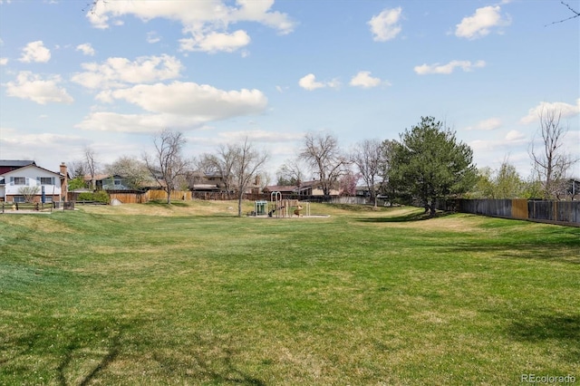 view of yard with playground community and fence