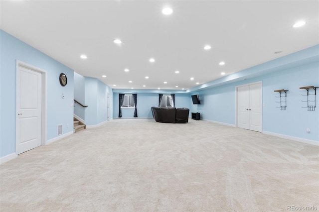 unfurnished living room featuring light carpet