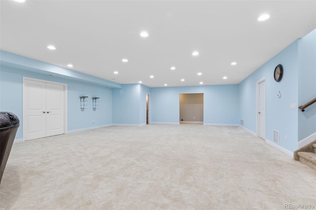 basement featuring light colored carpet