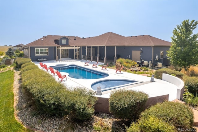 view of pool with an in ground hot tub and a patio