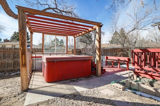 view of patio / terrace with a hot tub, a pergola, and a deck