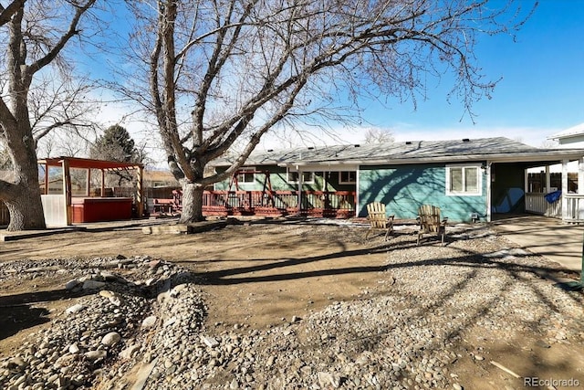 back of property with a hot tub