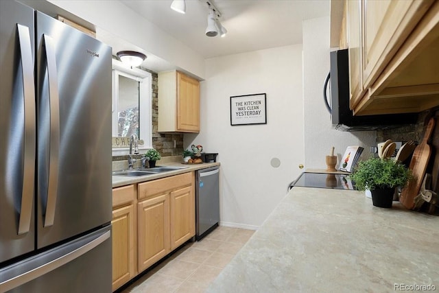 kitchen featuring track lighting, appliances with stainless steel finishes, light brown cabinetry, and sink