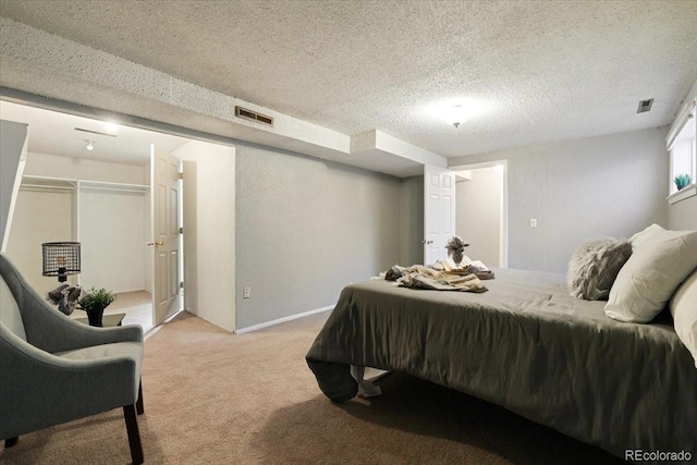 carpeted bedroom featuring a closet and a textured ceiling