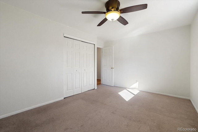 unfurnished bedroom with light carpet, a closet, and ceiling fan