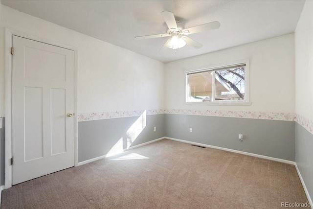 spare room with light carpet and ceiling fan