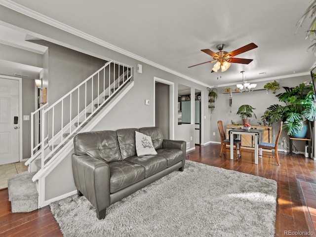 living area with crown molding, stairway, baseboards, and hardwood / wood-style flooring