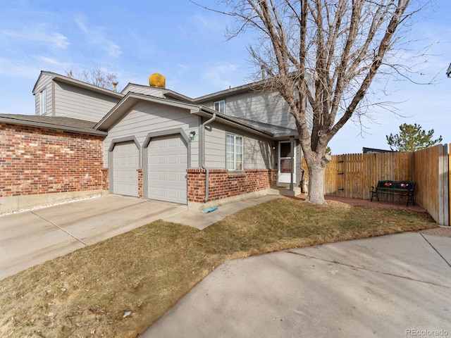 view of front of property featuring a garage, brick siding, driveway, and fence