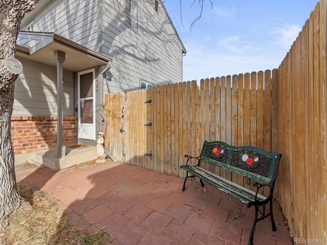 view of patio featuring a gate and fence