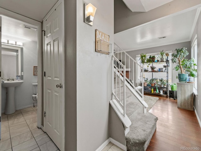 stairs with visible vents and baseboards