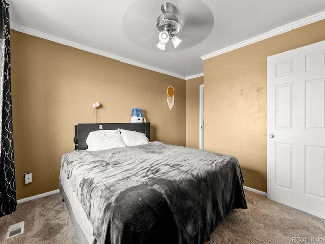 carpeted bedroom with visible vents, crown molding, baseboards, and ceiling fan