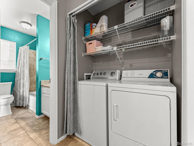 laundry room with laundry area, light tile patterned floors, and separate washer and dryer