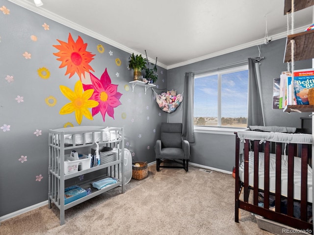 bedroom featuring ornamental molding, a crib, carpet, and baseboards